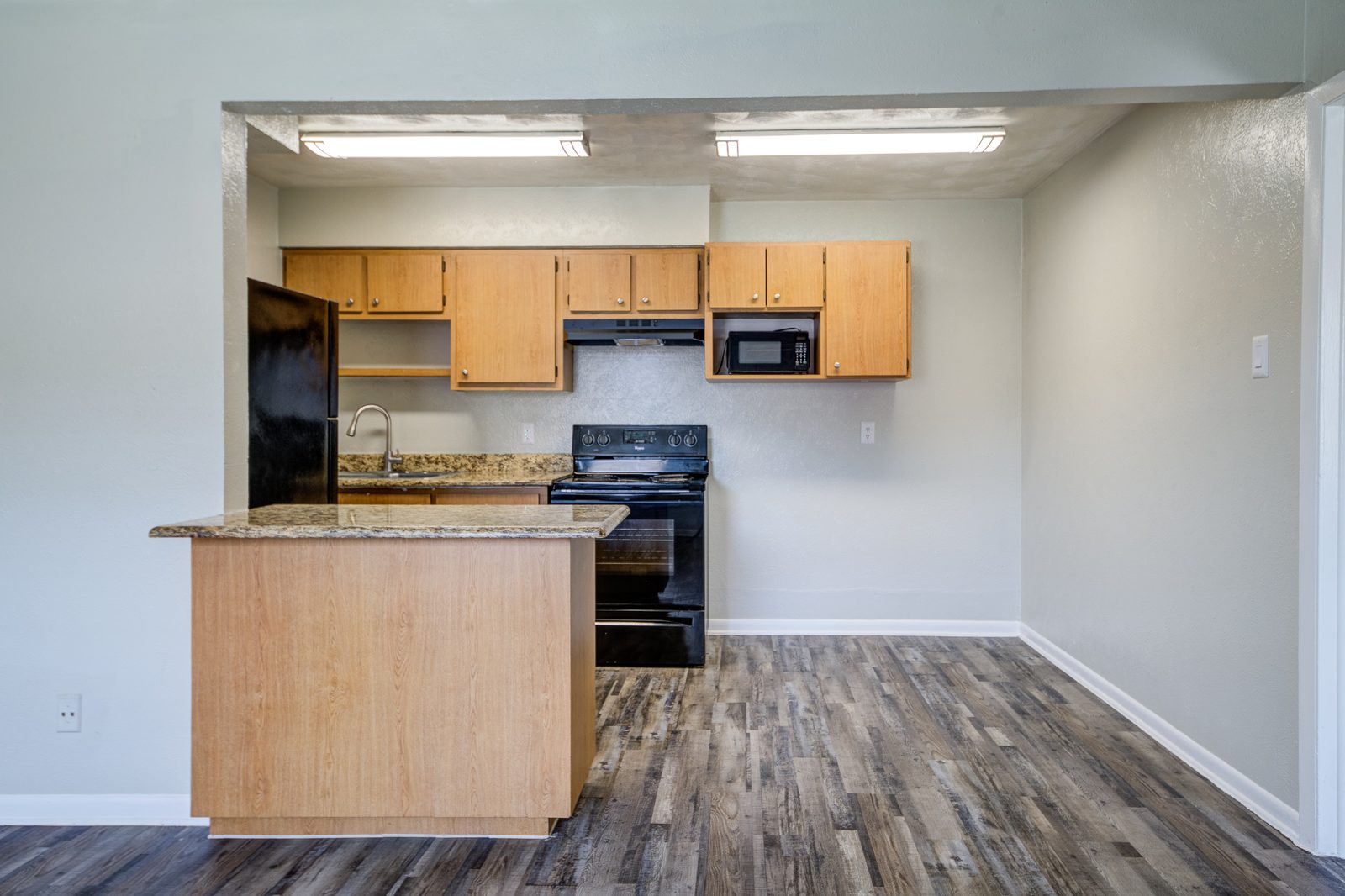 Dining area with a breakfast bar and the kitchen behind it