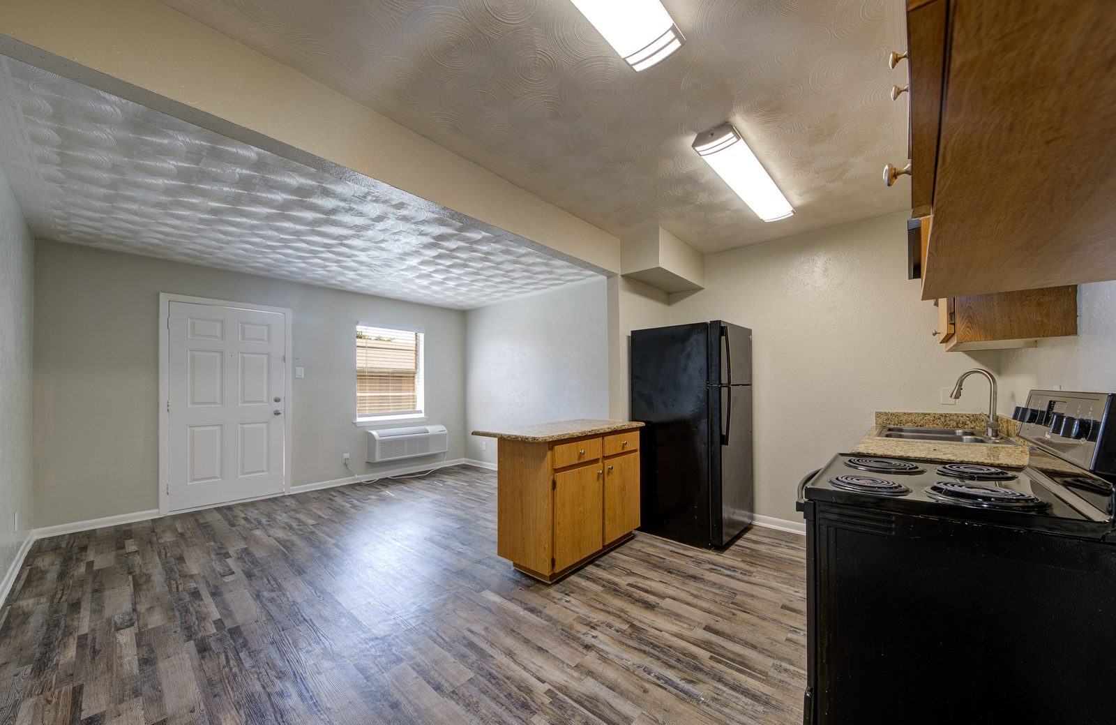 Open dining and living area with the kitchen on the right