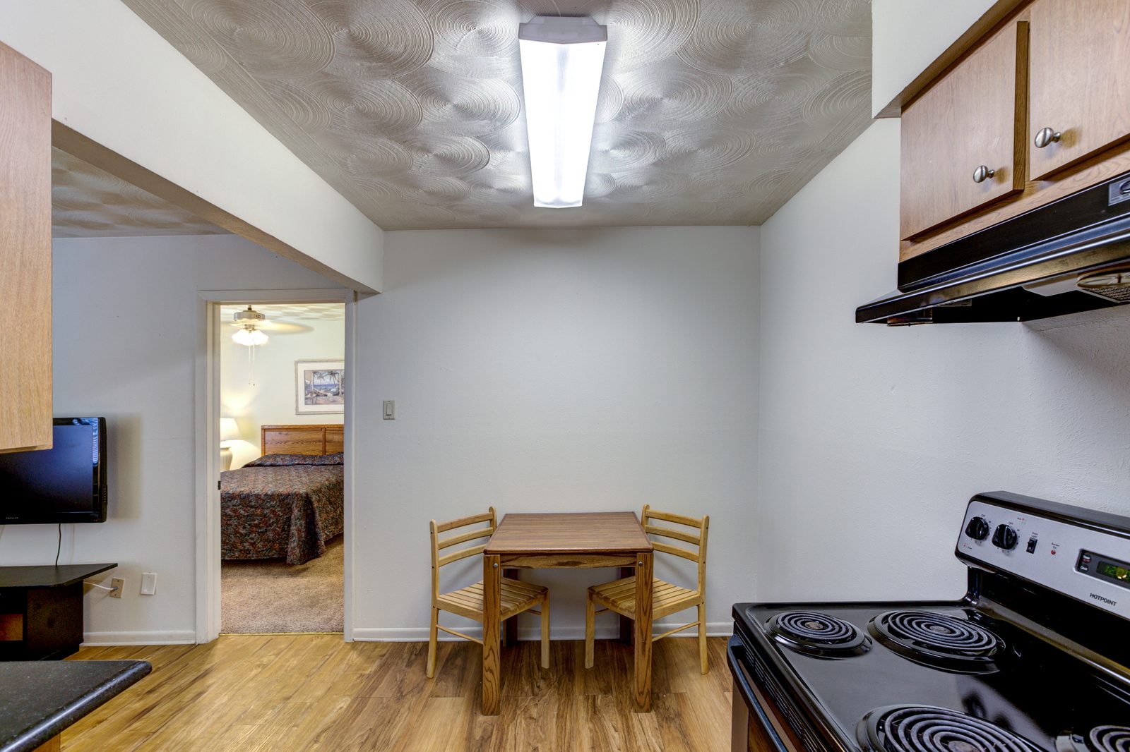 White Oak dining area with a table and chairs next to the kitchen