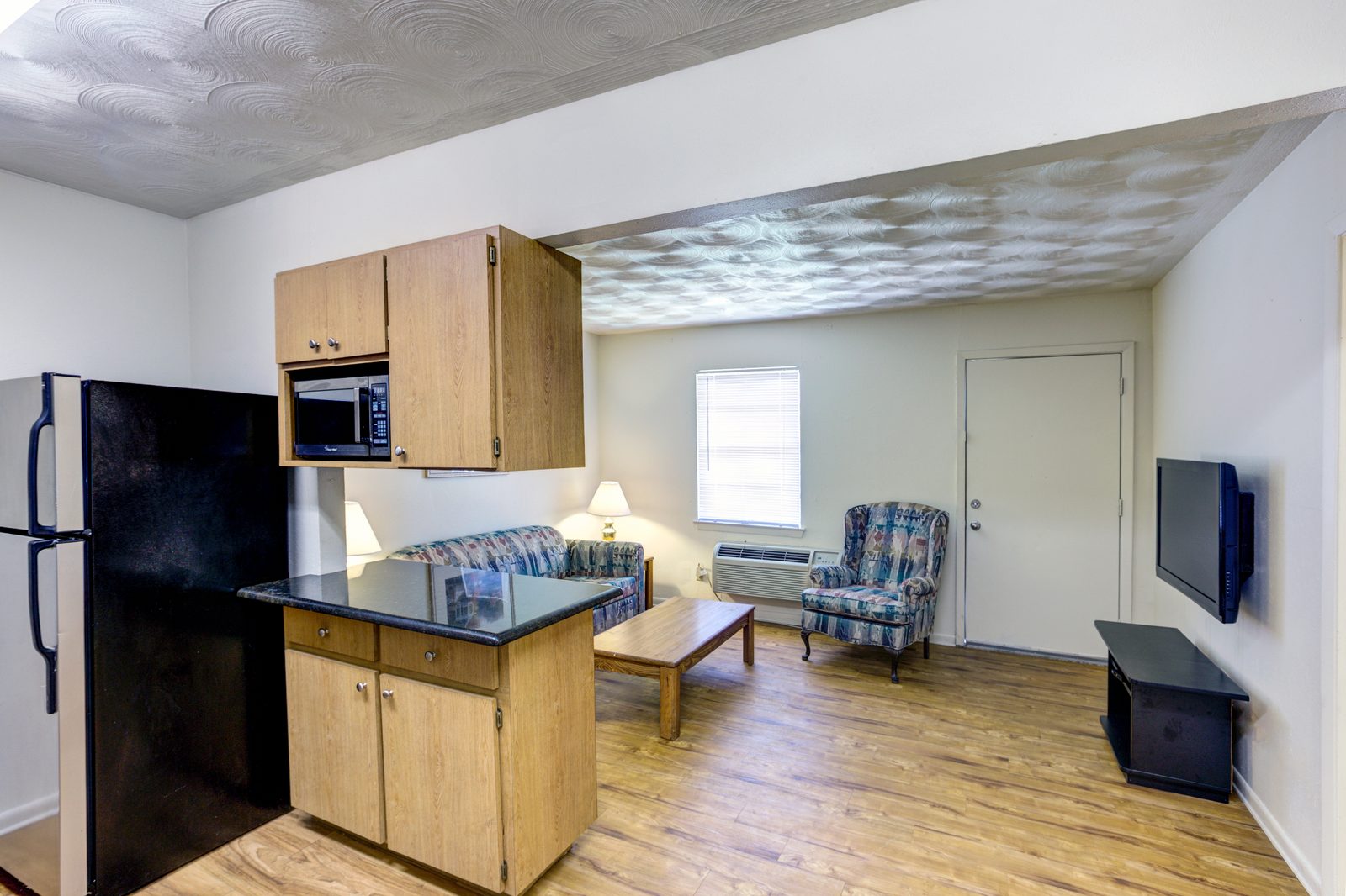 Furnished White Oak kitchen and living room with a breakfast bar